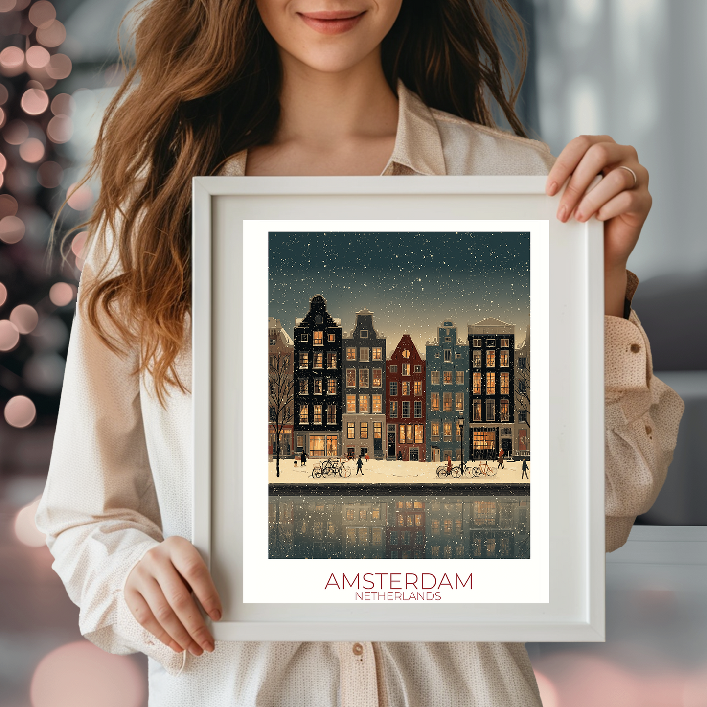 Person holding a framed print of Amsterdam with festive lights in the background