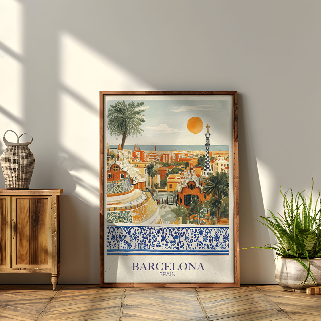 Framed artwork of Barcelona on a wall next to a wooden cabinet and plants.