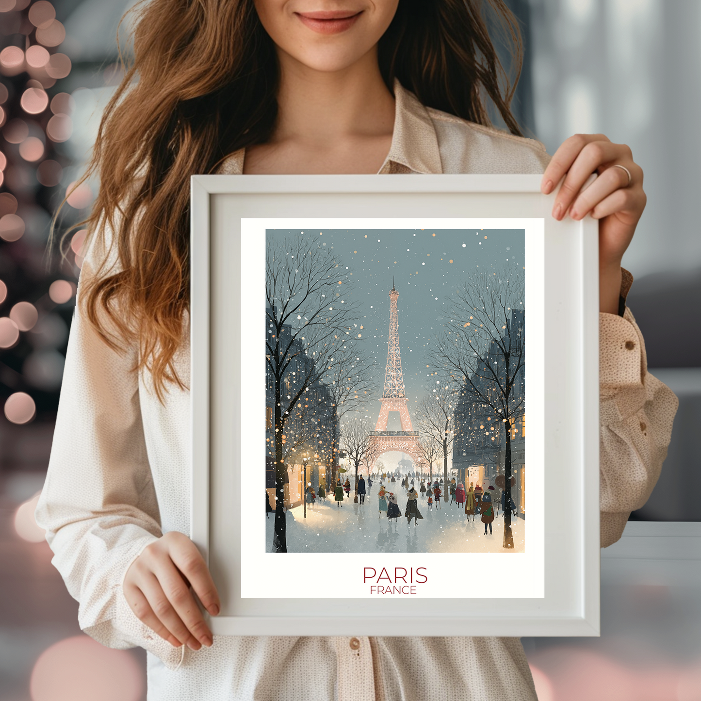 Person holding a framed picture of the Eiffel Tower in Paris with festive lights in the background.