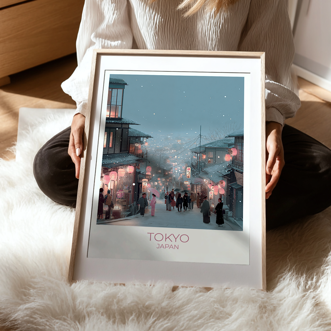 Framed artwork of a Tokyo street scene held by a person on a soft surface