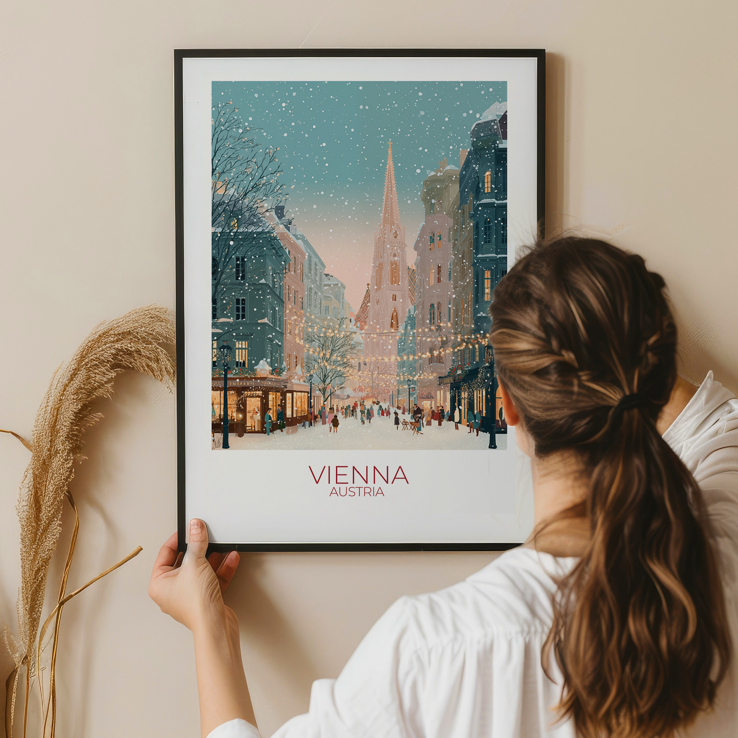 Person holding a framed print of Vienna, Austria during winter.