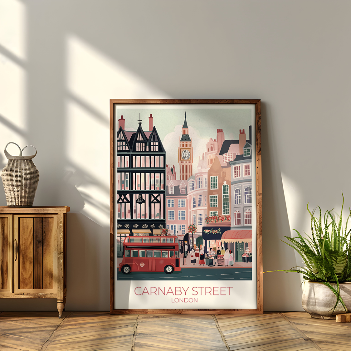 Framed artwork of a city street scene on a wall next to a wooden cabinet with plants.