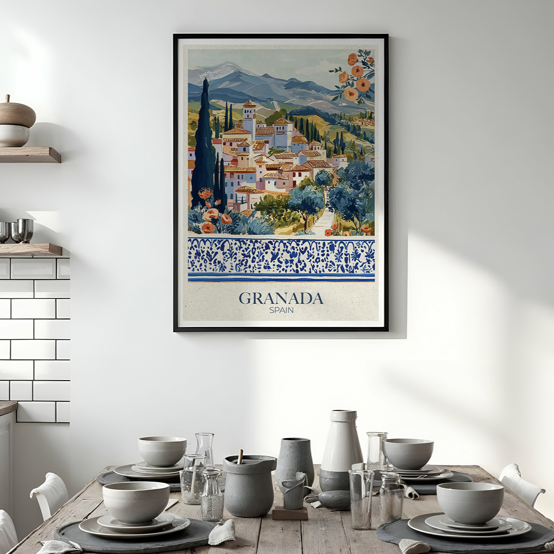 Framed artwork of Granada on a wall above a dining table with kitchen decor.