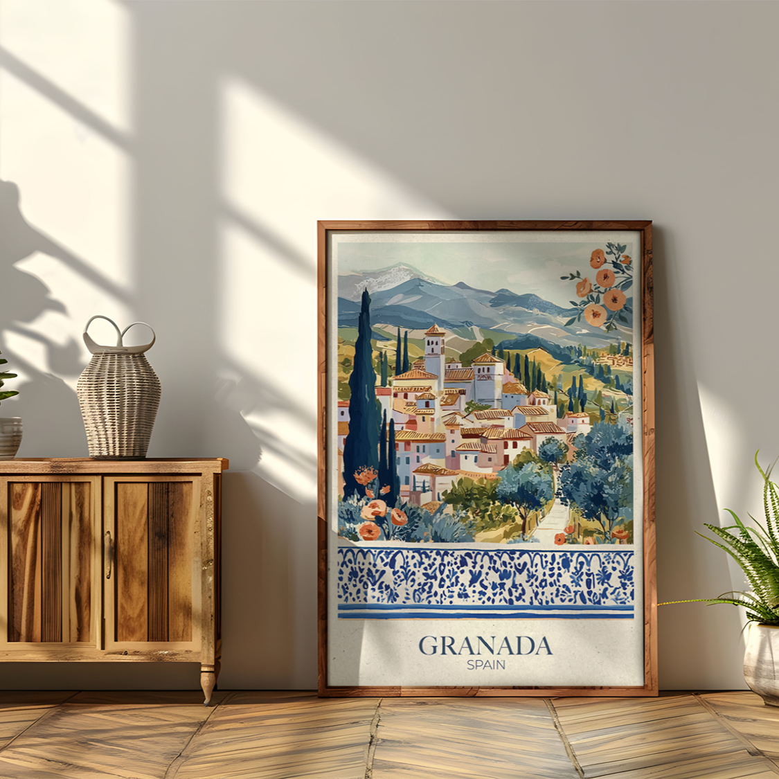 Framed artwork of a scenic view with 'Granada' text on a wall next to a wooden cabinet.