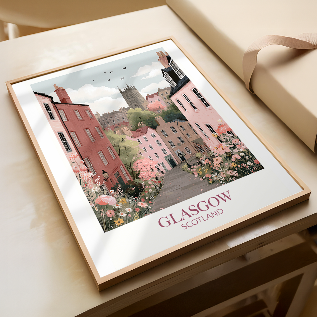 Framed artwork of a scenic view of Glasgow, Scotland on a wooden surface.