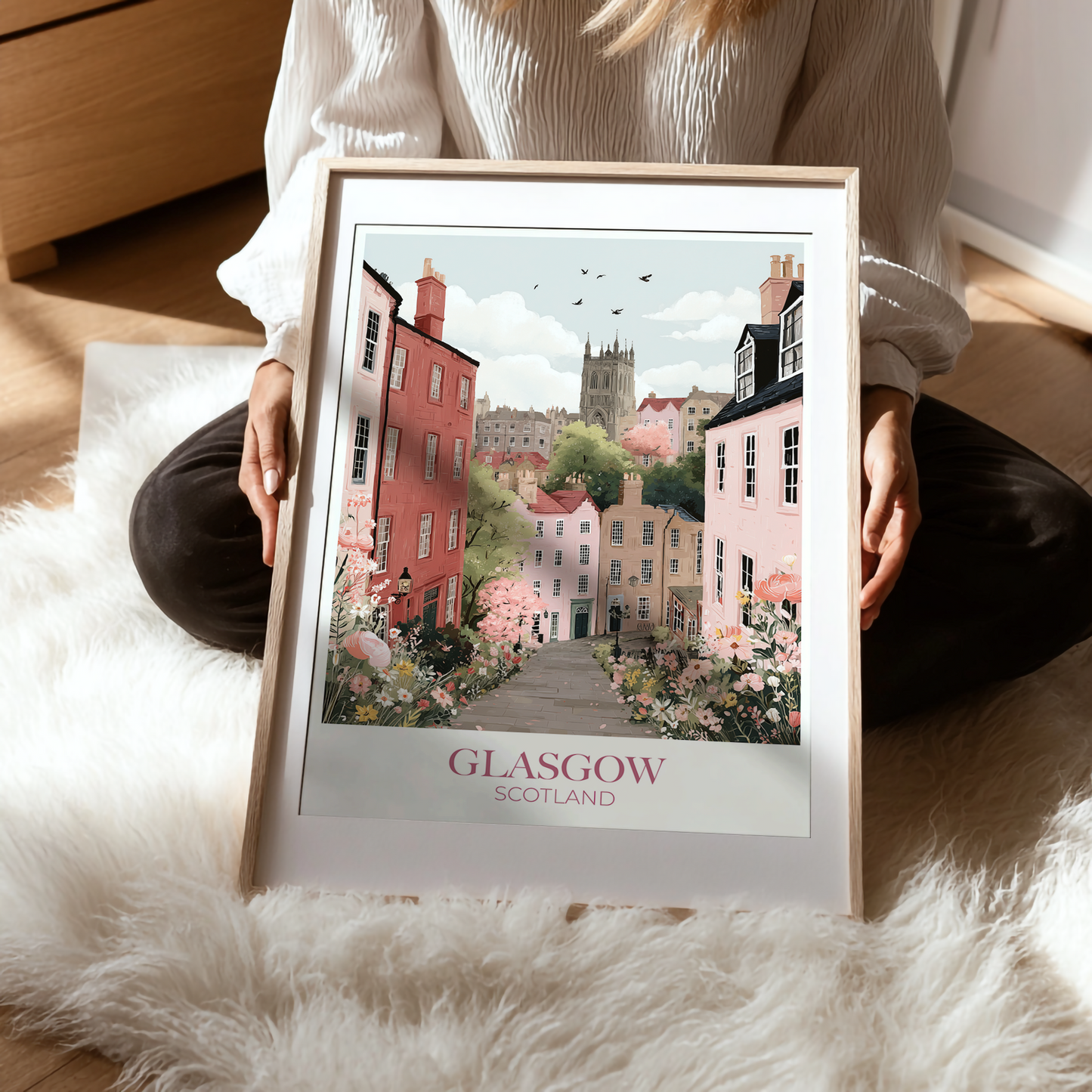 Person holding a framed print of Glasgow, Scotland on a soft surface