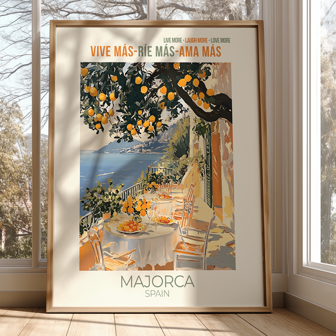 Framed artwork of a scenic view with a table set outdoors, featuring oranges and a body of water.