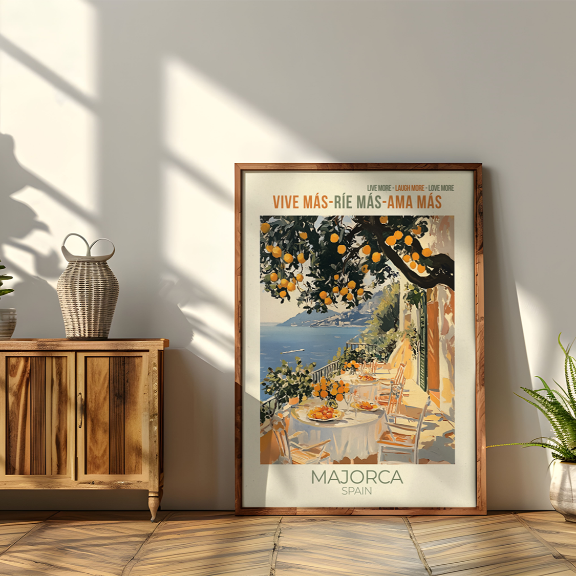 Framed poster of a scenic view with text on a wall next to a wooden cabinet and plants.