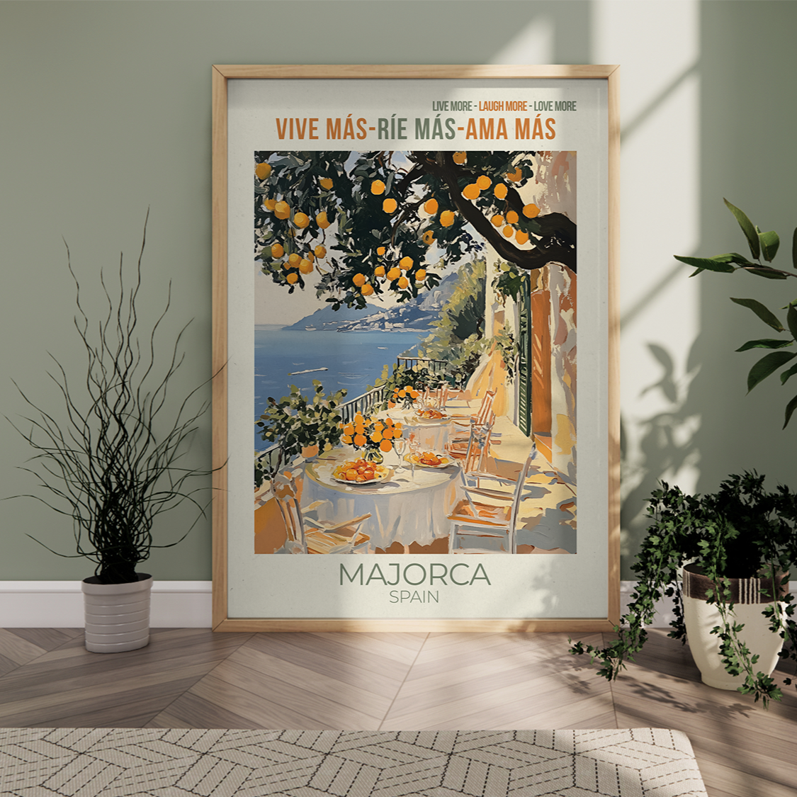 Framed travel poster for Majorca on a wall in a room with plants.