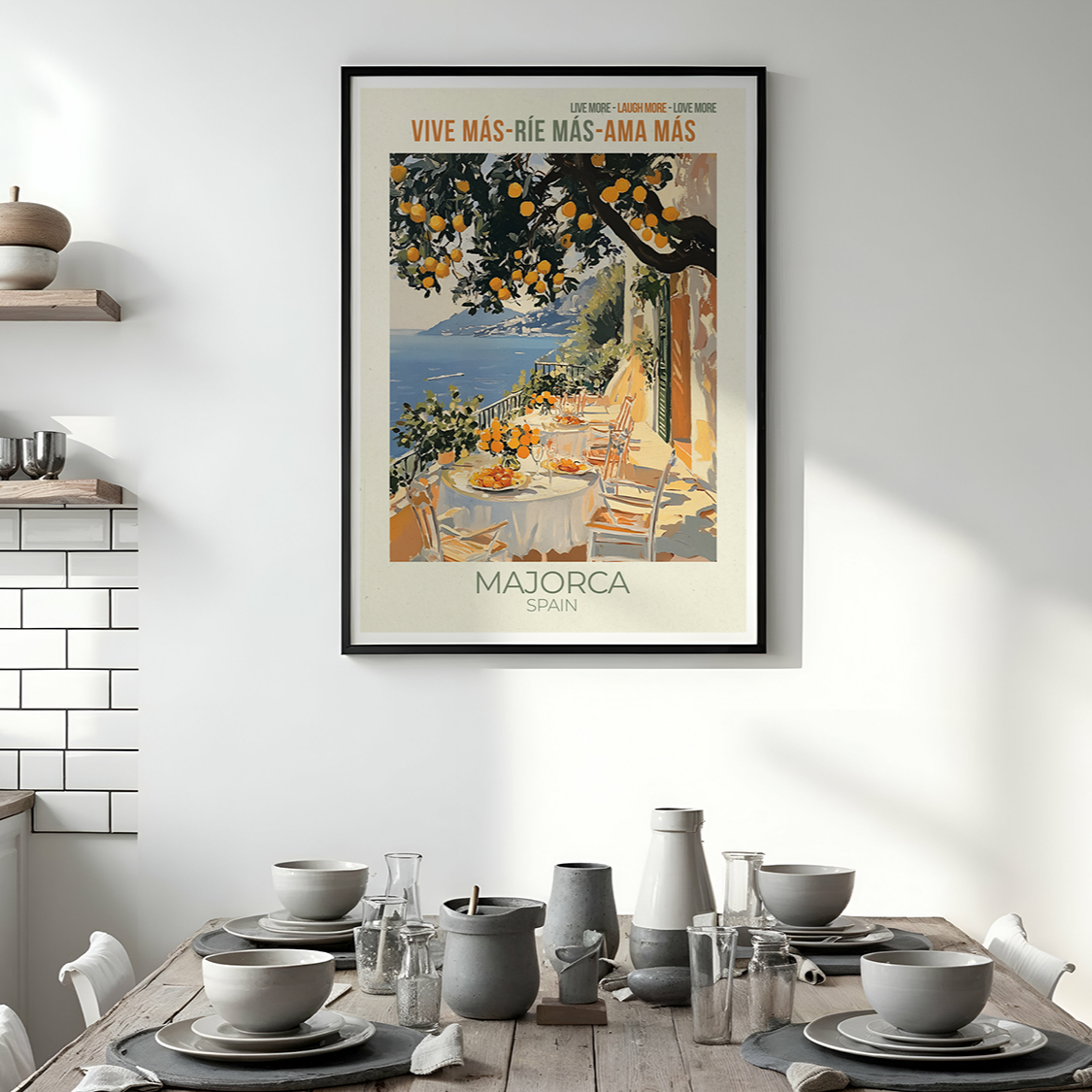 Framed travel poster for Majorca above a dining table with kitchen decor.