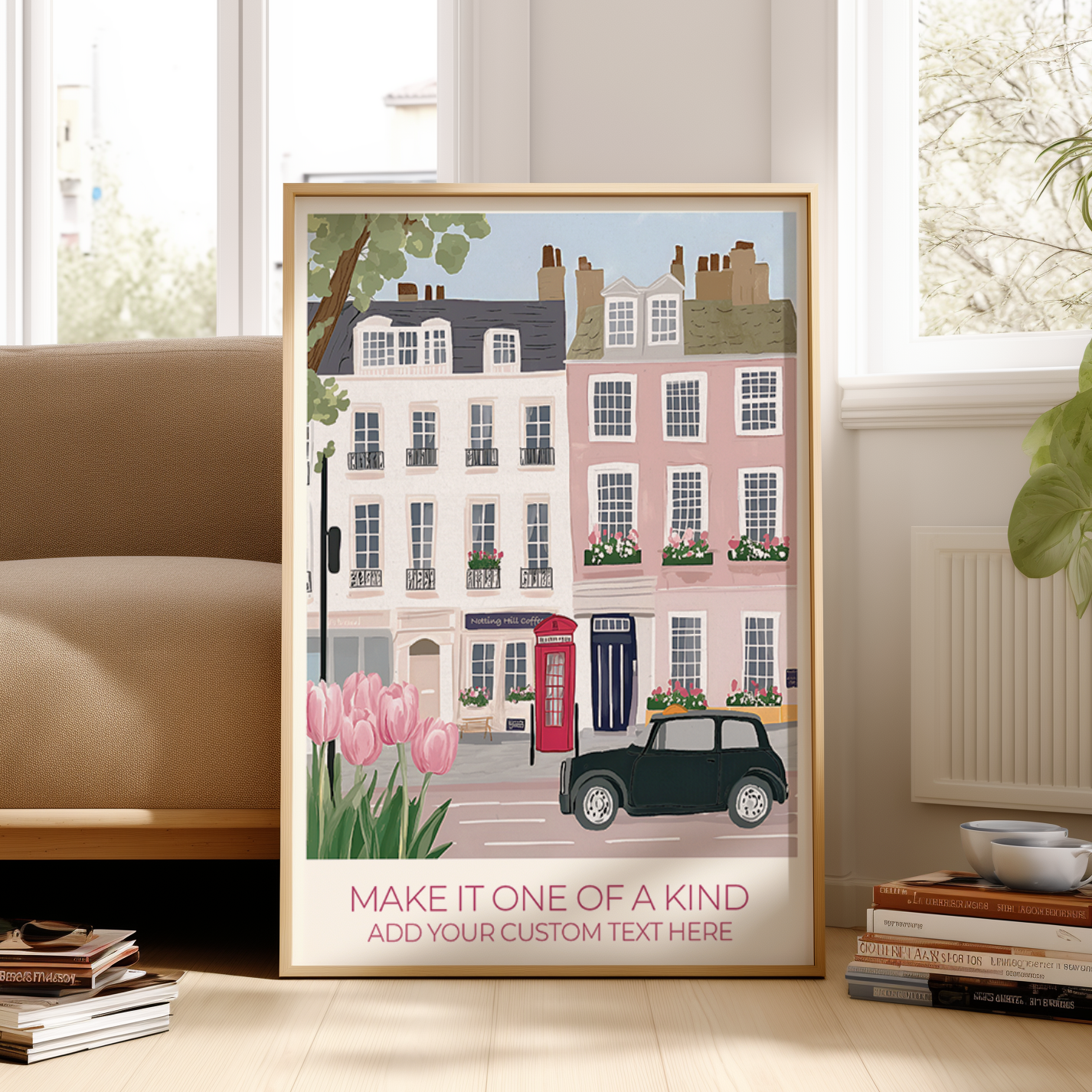Framed artwork of a street scene with houses, a car, and pink tulips on a wall in a room.