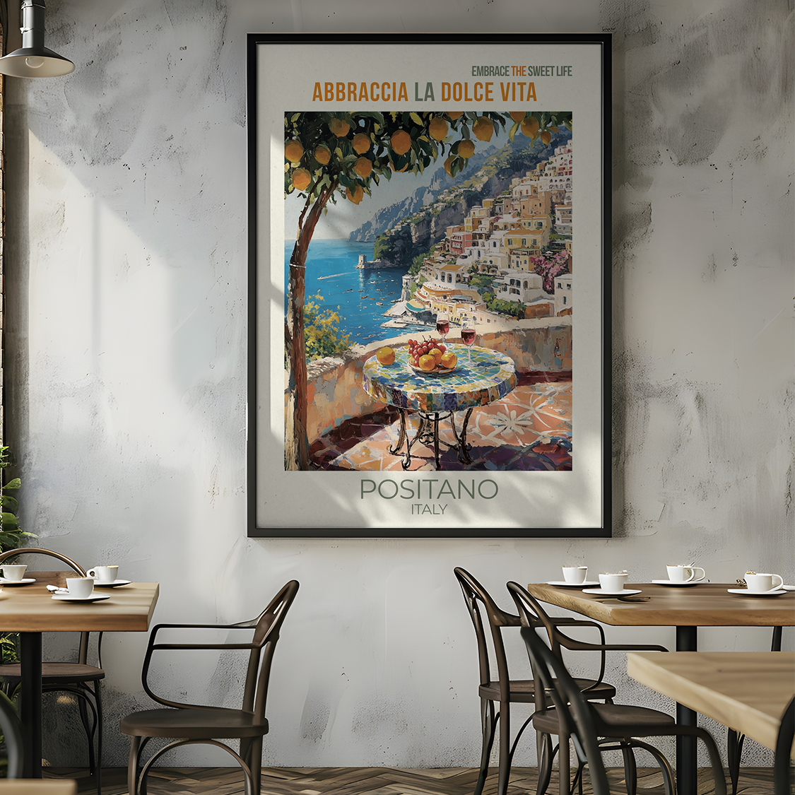 Restaurant interior with a framed artwork of Positano, Italy on the wall.