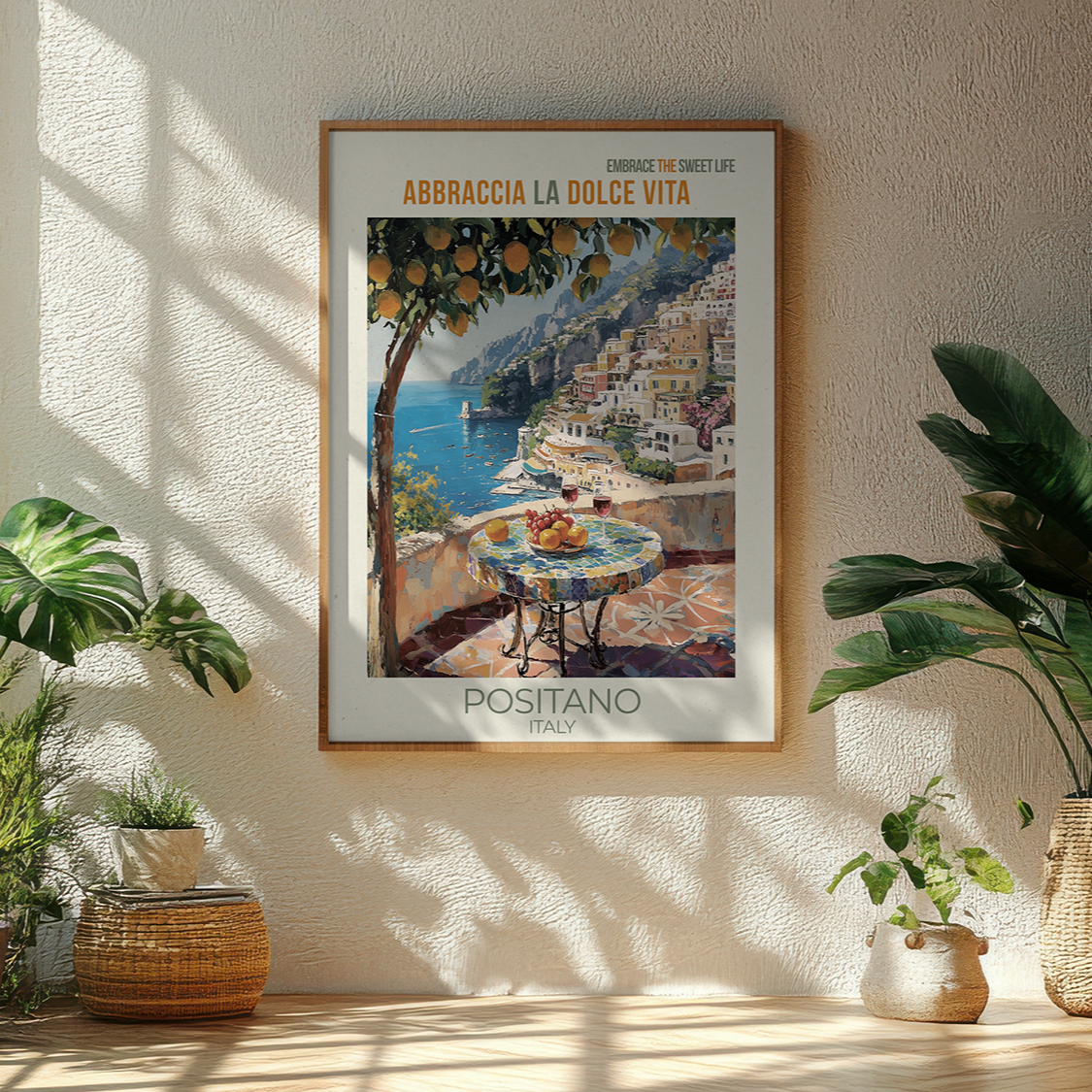 Framed artwork of Positano, Italy, on a wall with plants around.
