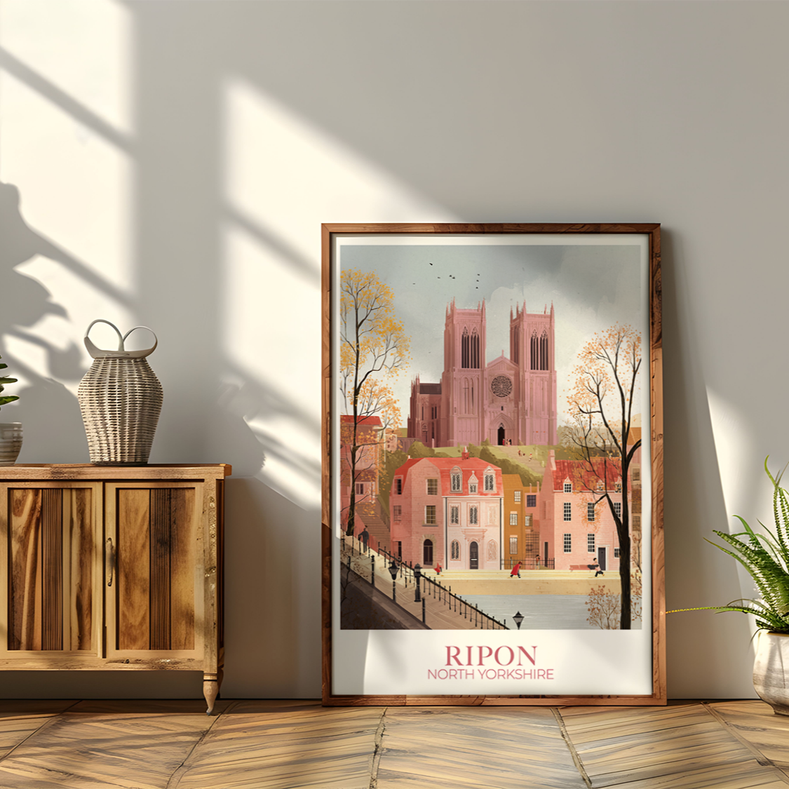 Framed artwork of a cityscape with 'Ripon' text on a wall with wooden cabinet and plants.