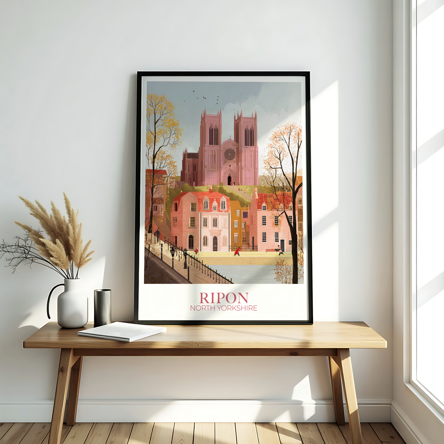 Framed artwork of Ripon Cathedral on a wooden bench against a white wall.