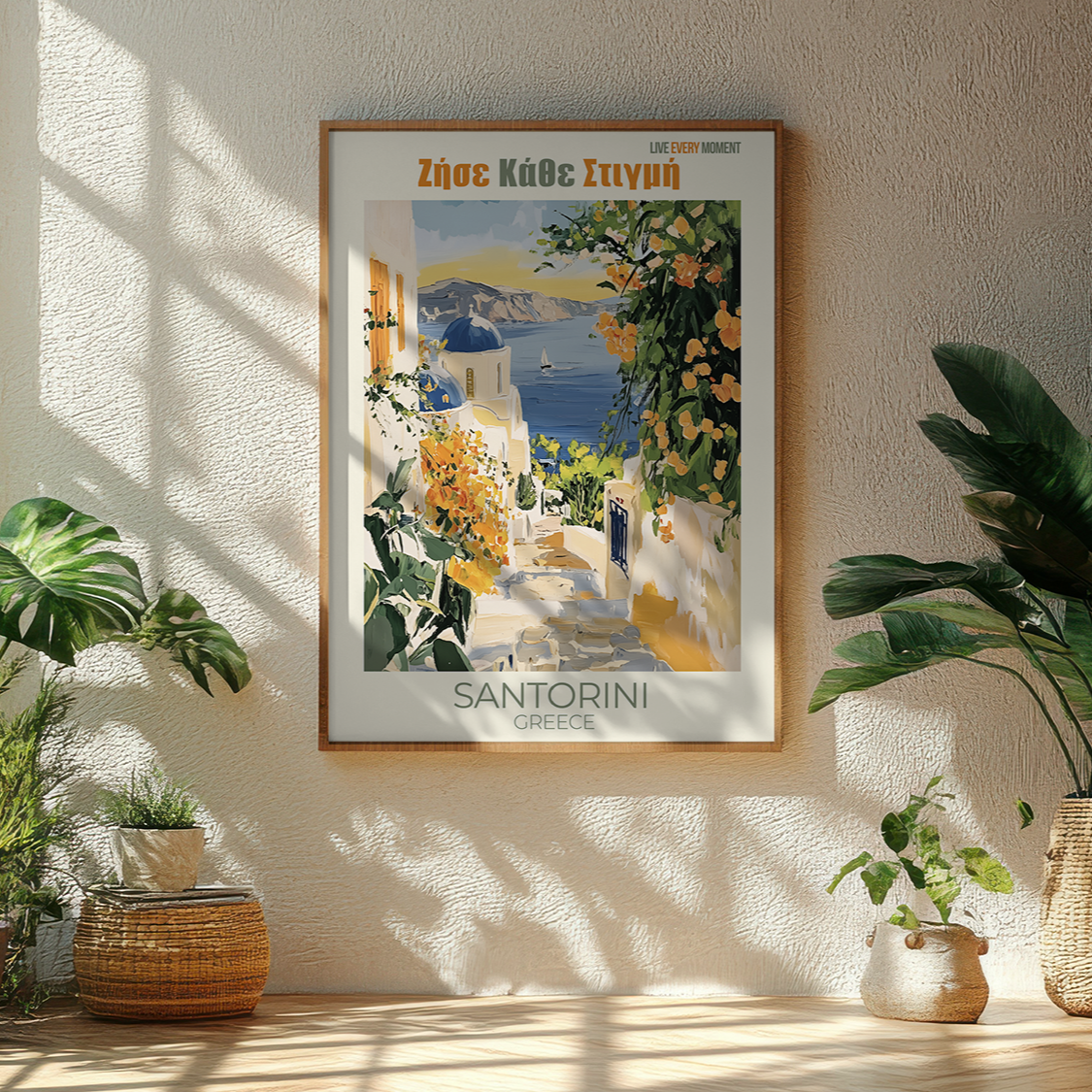Framed Santorini travel poster on a wall with plants around