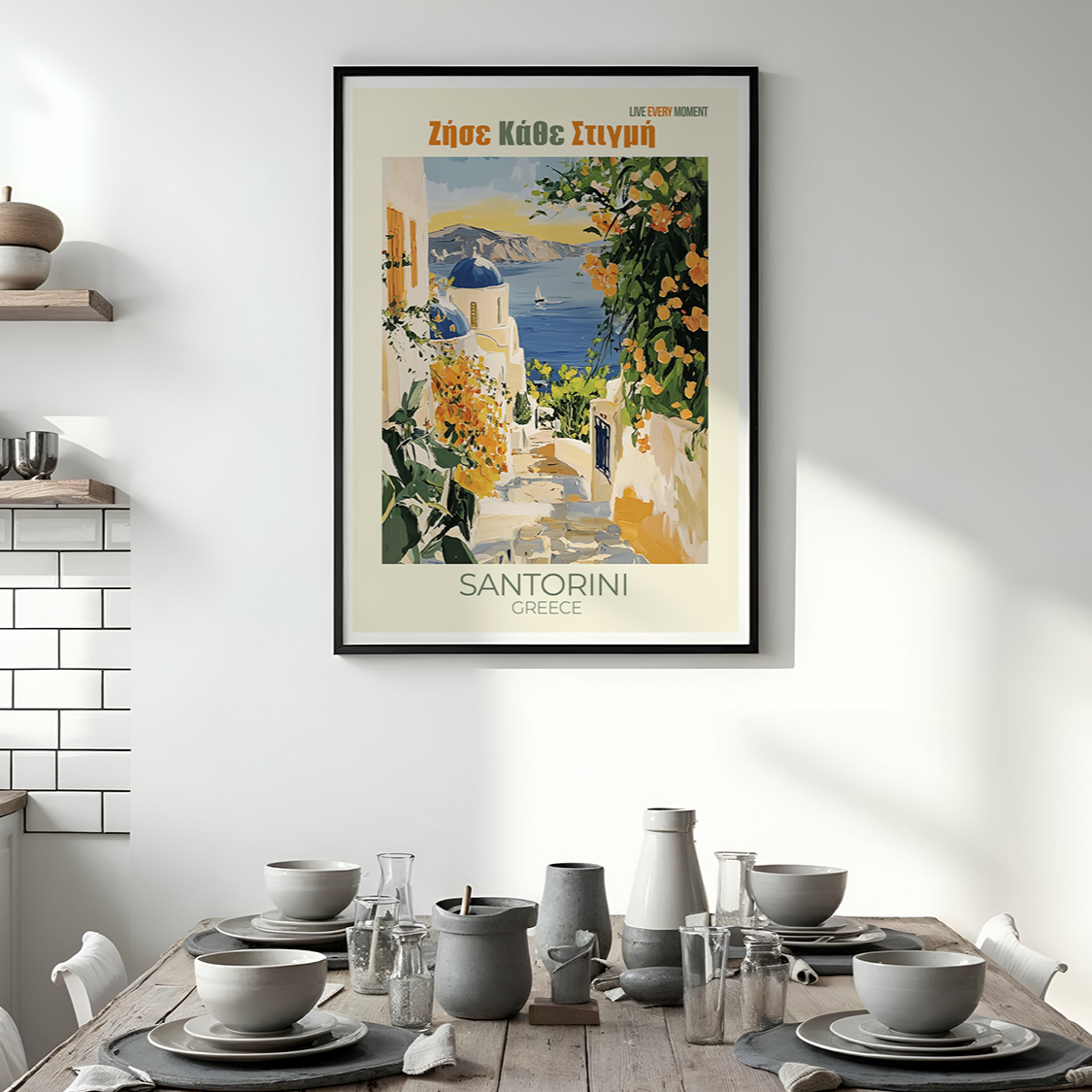 Framed Santorini travel poster in a modern kitchen with a dining table.