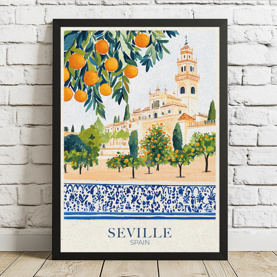 Framed artwork of Seville, Spain with oranges and a building on a white brick wall.