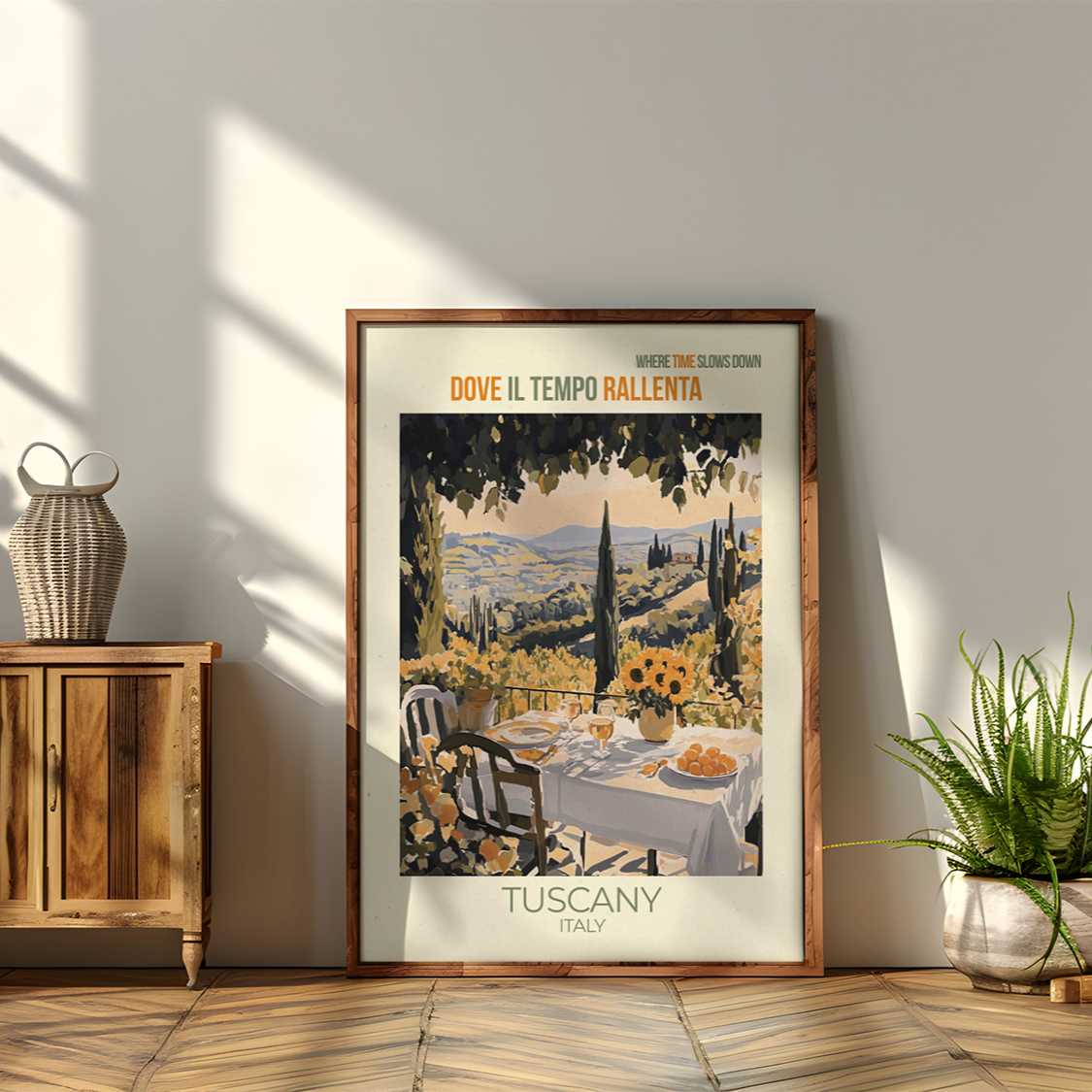Framed Tuscany travel poster on a wall with wooden cabinet and plants.