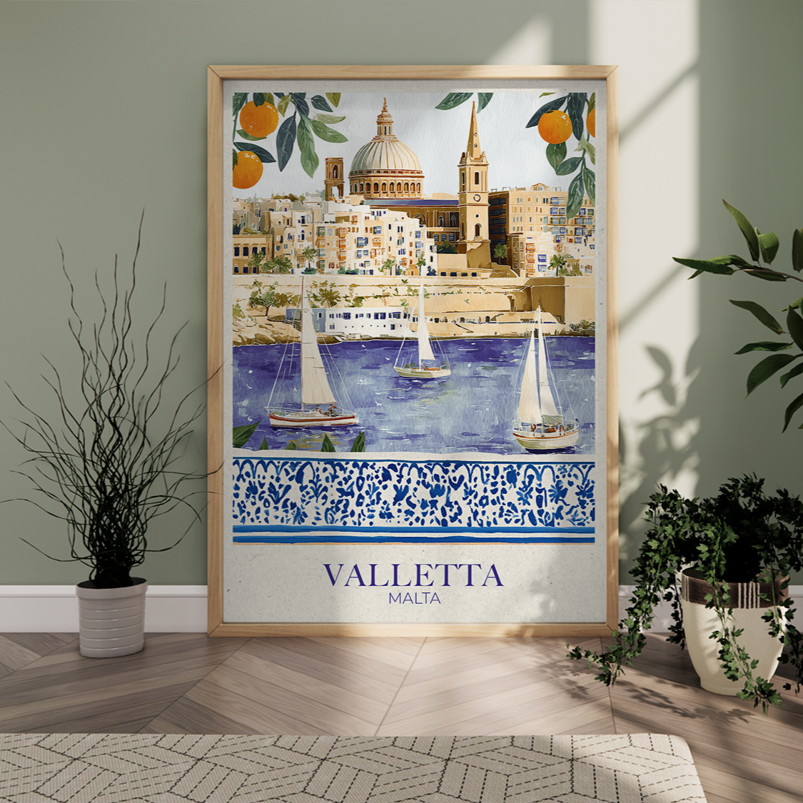 Framed artwork of Valletta, Malta with sailboats and architectural elements, displayed in a room with plants.