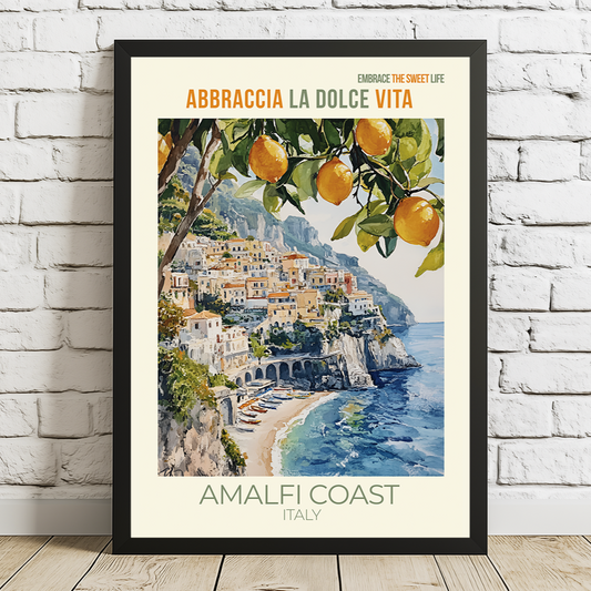 Framed artwork of the Amalfi Coast with oranges on a white brick wall.