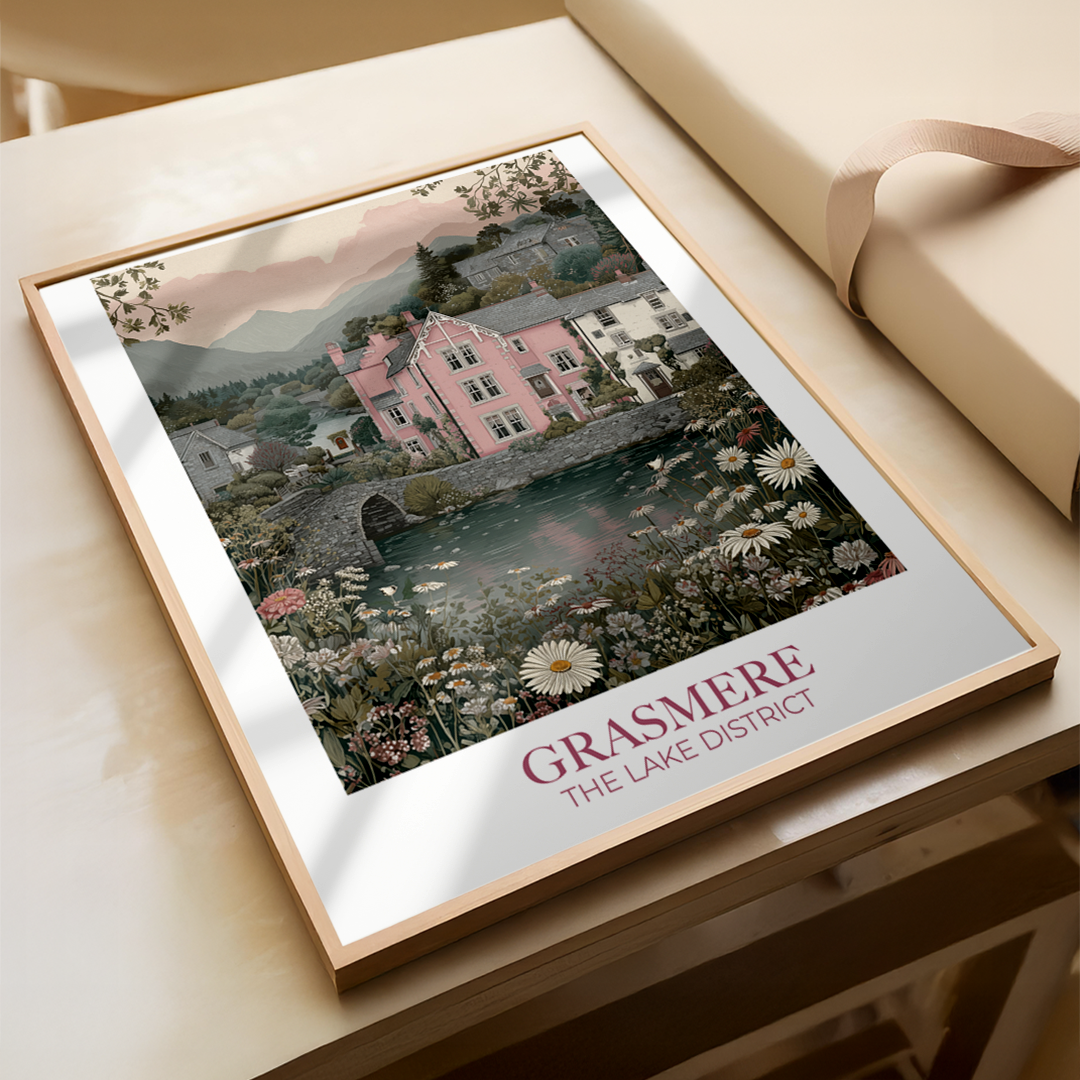 Framed artwork of a scenic view with 'Grasmere The Lake District' text on a wooden surface.