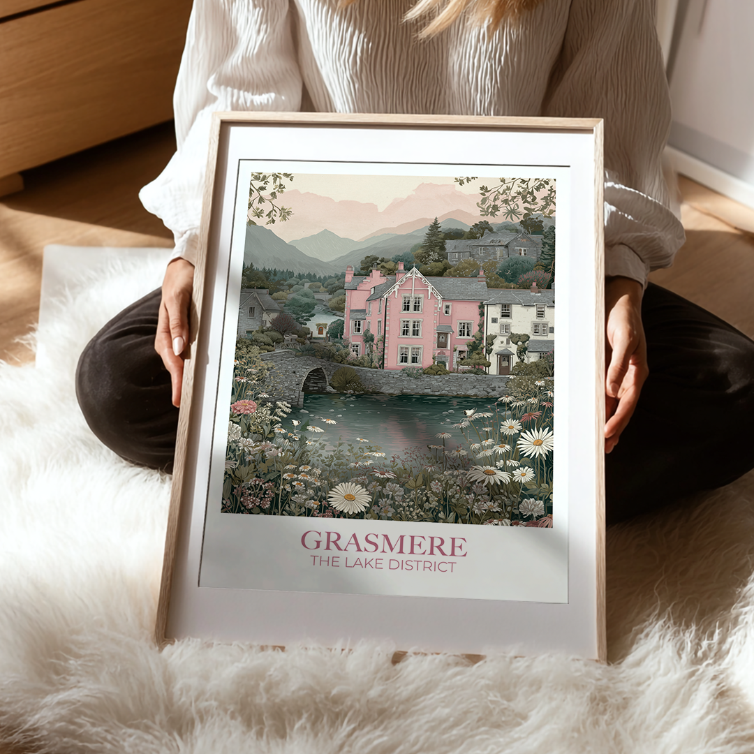 Person holding a framed print of Grasmere, The Lake District with a scenic view.