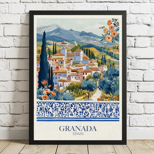 Framed artwork of Granada, Spain with scenic village and mountains on a white brick wall.