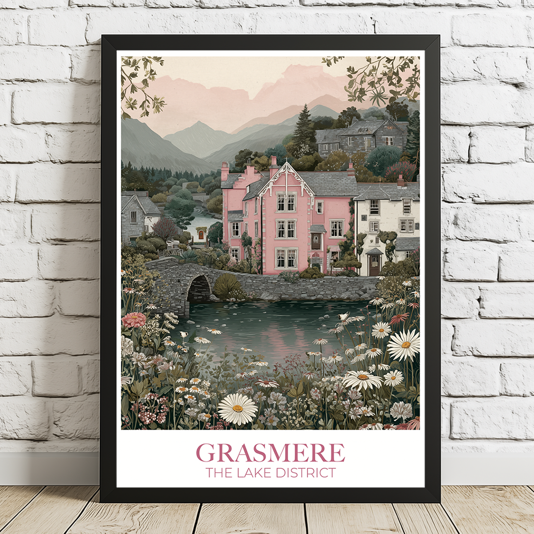 Framed artwork of a scenic village with a pink house, lake, and mountains on a white brick wall.