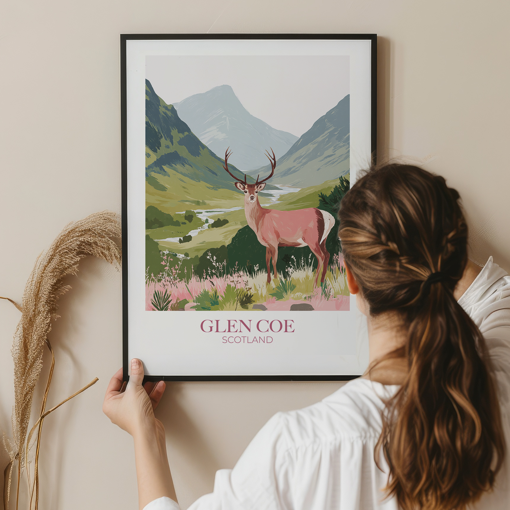 Person holding a framed print of a deer in Glen Coe, Scotland