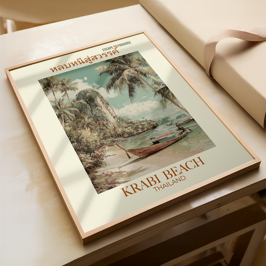 Framed artwork of Krabi Beach, Thailand with a boat and palm trees on a table.