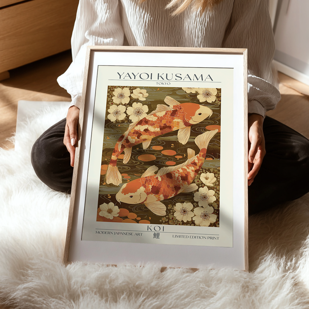 Person holding a framed Yayoi Kusama art print featuring koi fish and flowers.