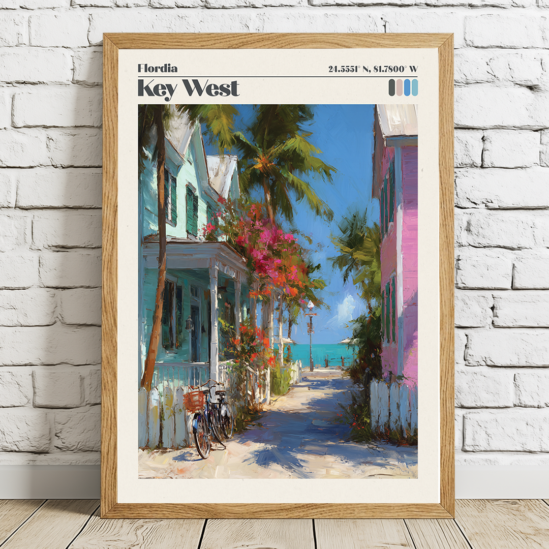 Framed artwork of a tropical street scene with colorful houses and palm trees on a white brick wall.