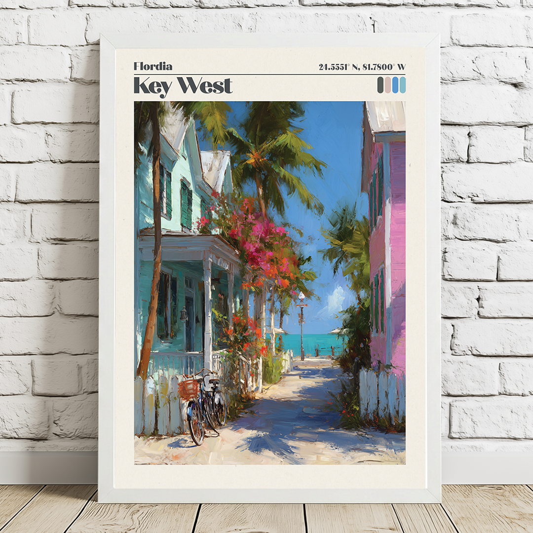Framed artwork of a tropical street scene with colorful houses and palm trees on a white brick wall.