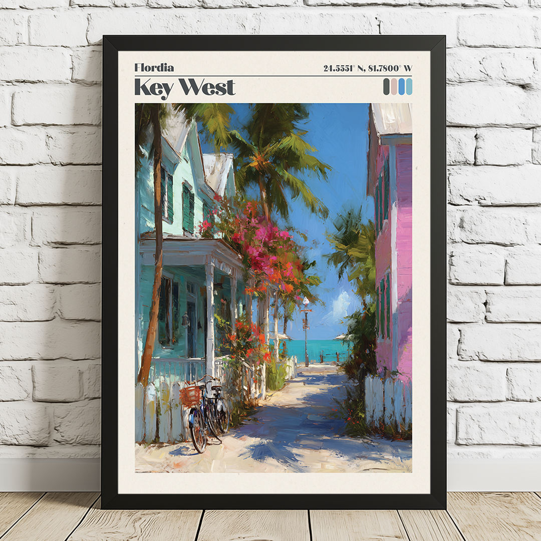 Framed artwork of a tropical street scene with colorful buildings and palm trees on a white brick wall.