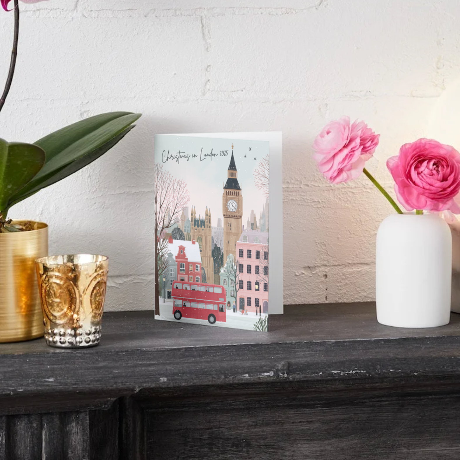 Christams Card with a London-themed design on a wooden surface with decorative items.