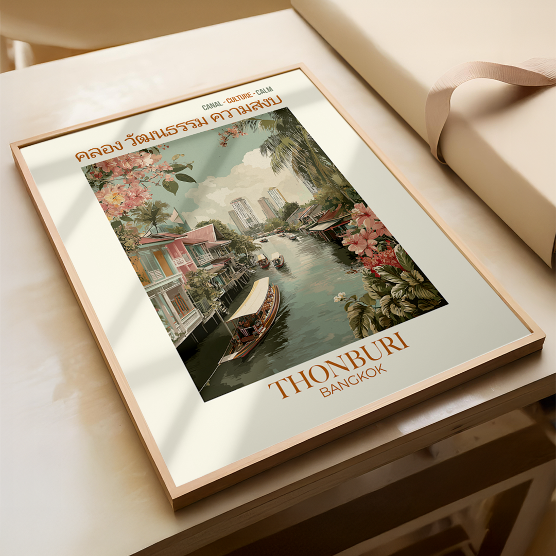 Framed artwork of a scenic view with 'Thonburi Bangkok' text on a wooden surface.