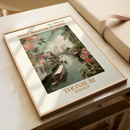 Framed artwork of a scenic view with 'Thonburi Bangkok' text on a wooden surface.