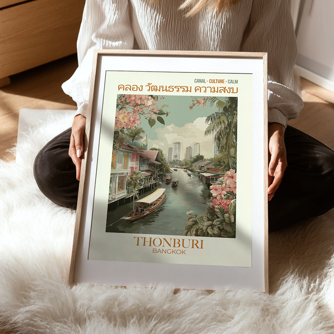 Person holding a framed poster of Thonburi Bangkok with a canal scene.