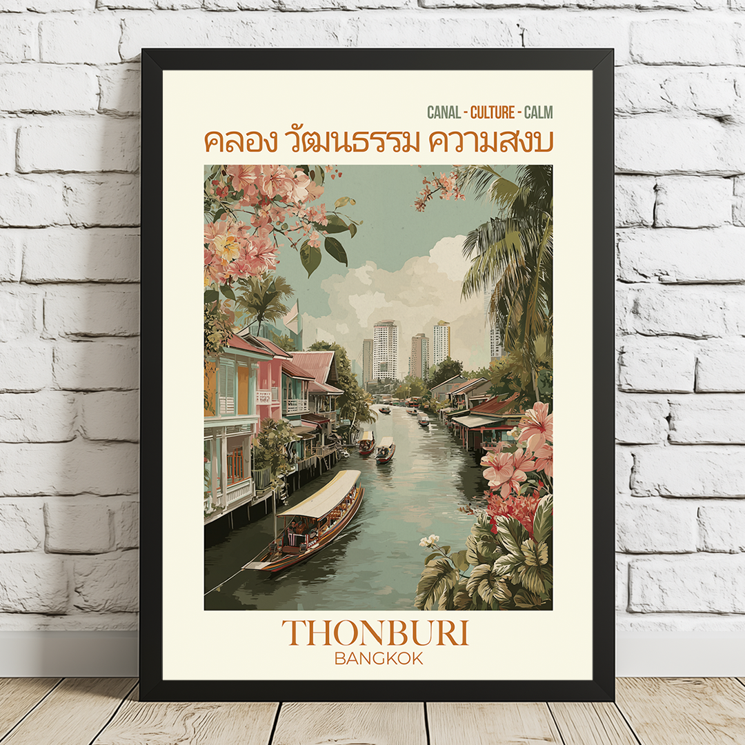 Framed poster of Thonburi Bangkok with canal scene and floral elements on a white brick wall.