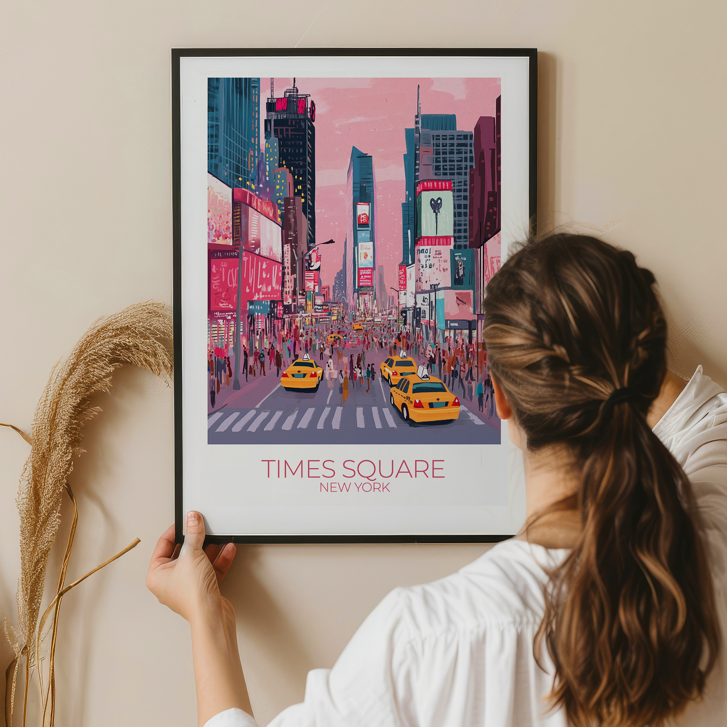 Person holding a framed print of Times Square, New York