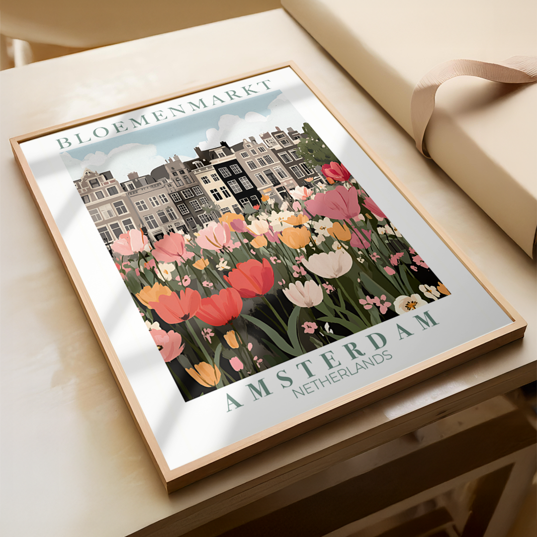 Framed artwork of a floral market in Amsterdam on a wooden surface.