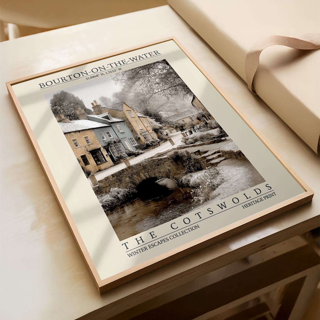 Framed print of Bourton-on-the-Water in The Cotswolds on a wooden surface.