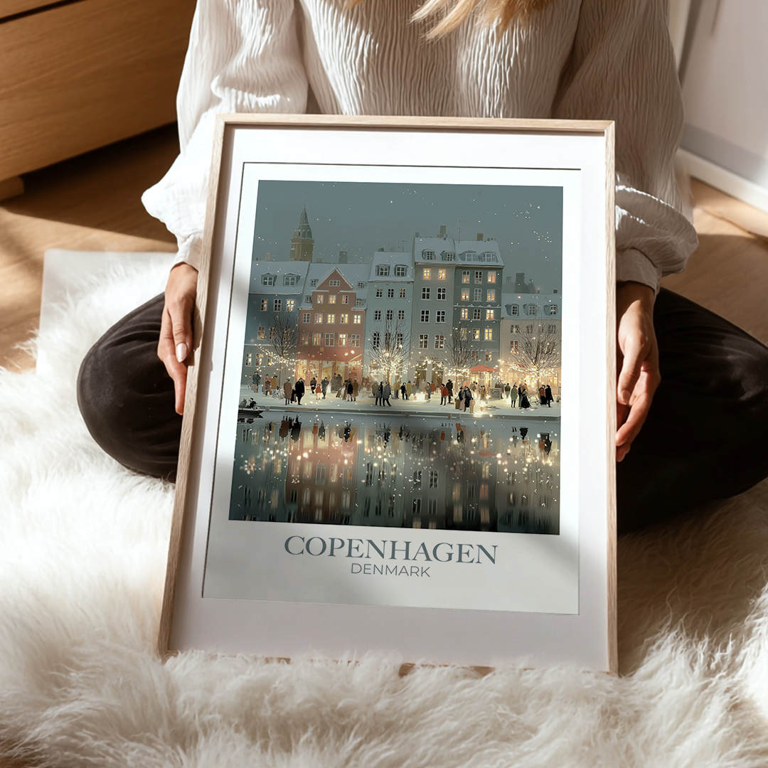 Person holding a framed picture of Copenhagen, Denmark on a soft surface
