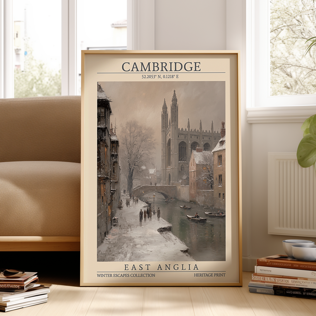Framed poster of Cambridge with a river scene, placed on a surface in a room.