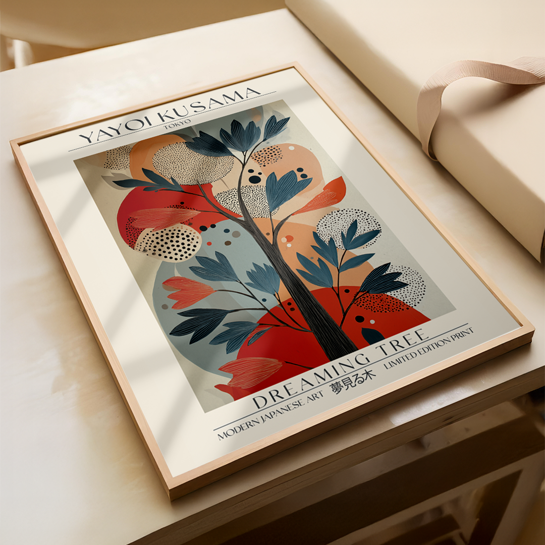 Framed artwork by Yayoi Kusama titled 'Dreaming Tree' on a wooden surface.