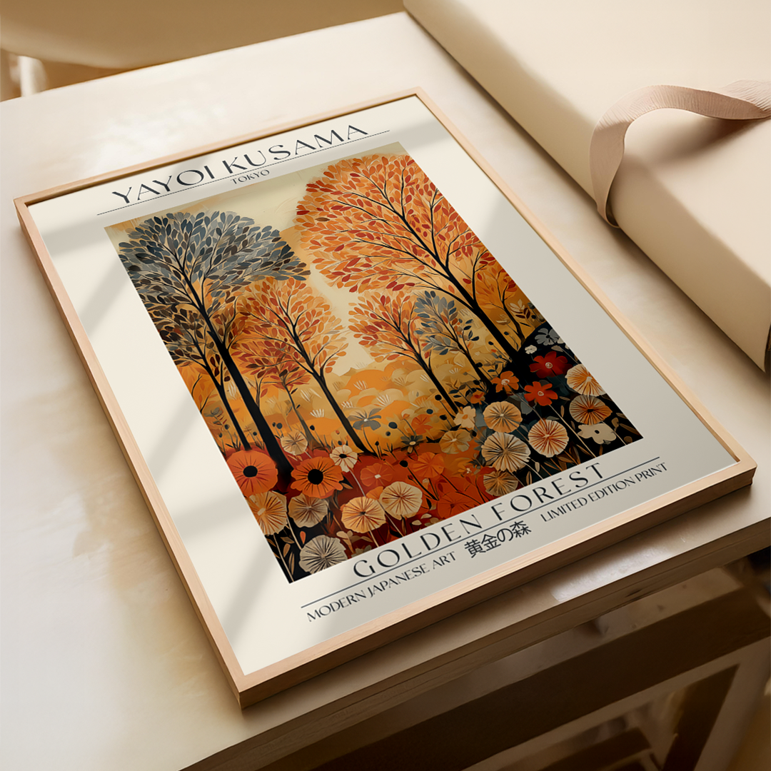 Framed artwork titled 'Golden Forest' by Yayoi Kusama on a light wooden surface.