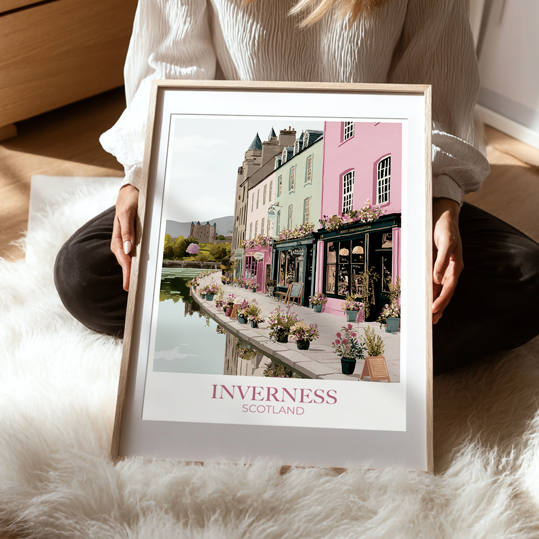 Person holding a framed picture of Inverness, Scotland on a soft surface