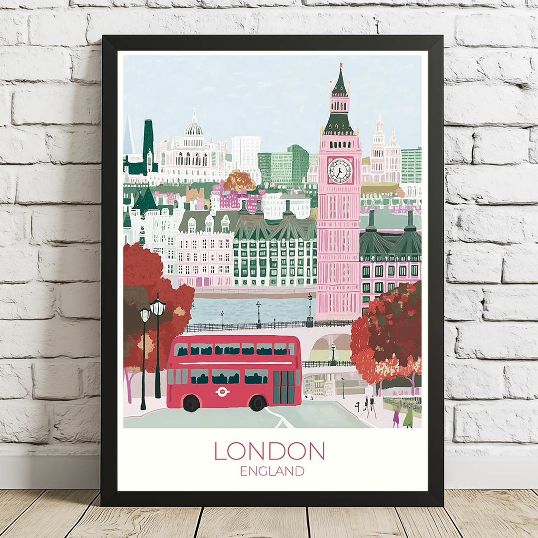 Framed artwork of London skyline with Big Ben and a red bus on a white brick wall background.