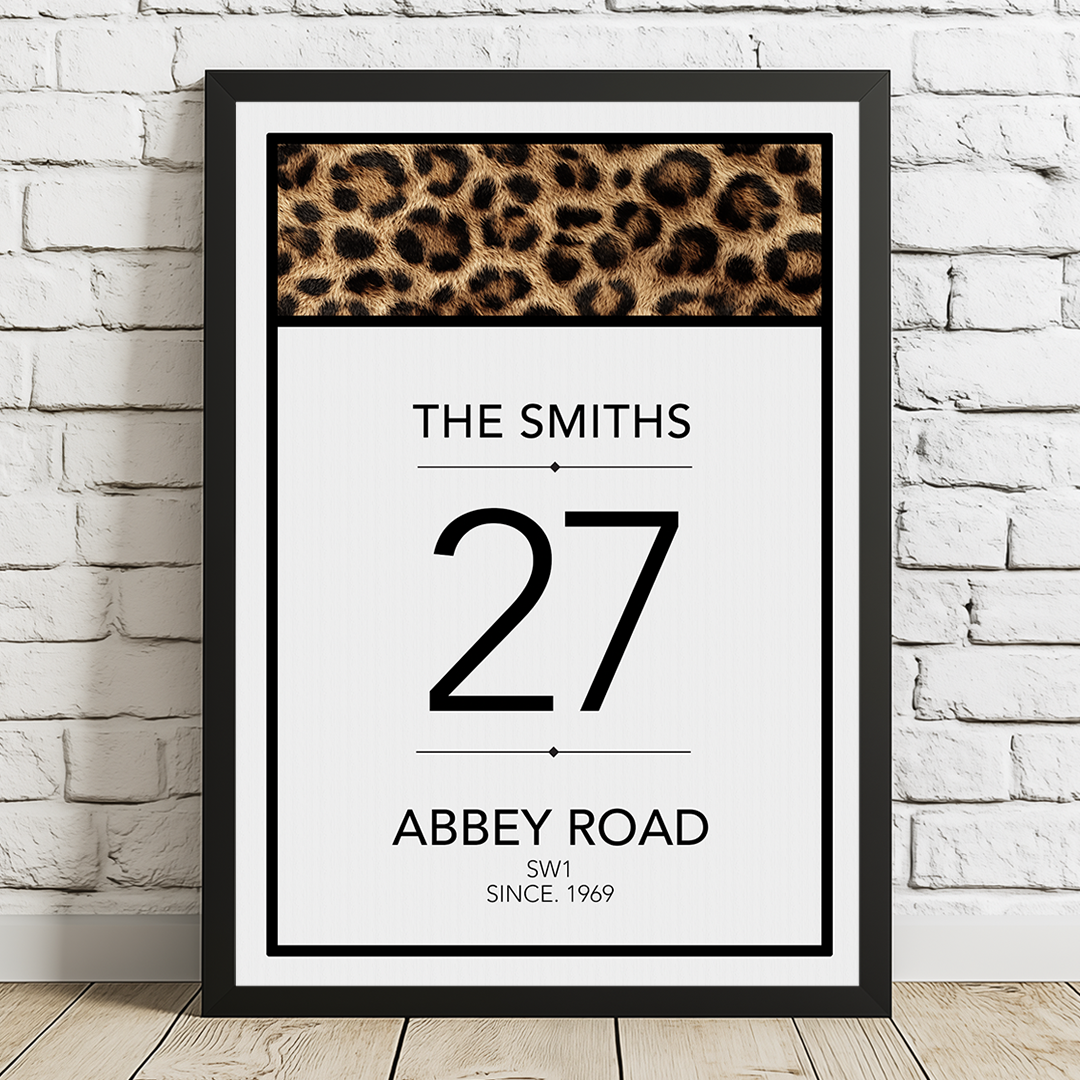 Framed print with leopard print at the top, text below, and a white brick wall background.